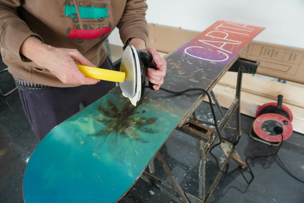 Melting wax onto a snowboard