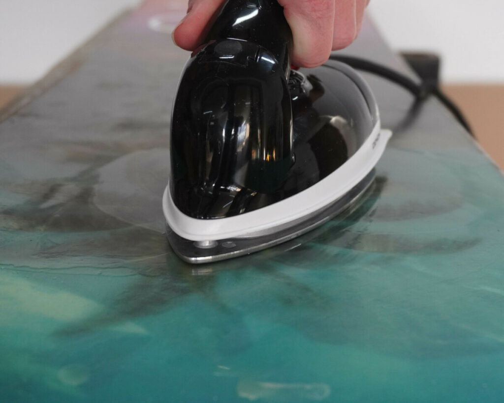 ironing wax onto a snowboard